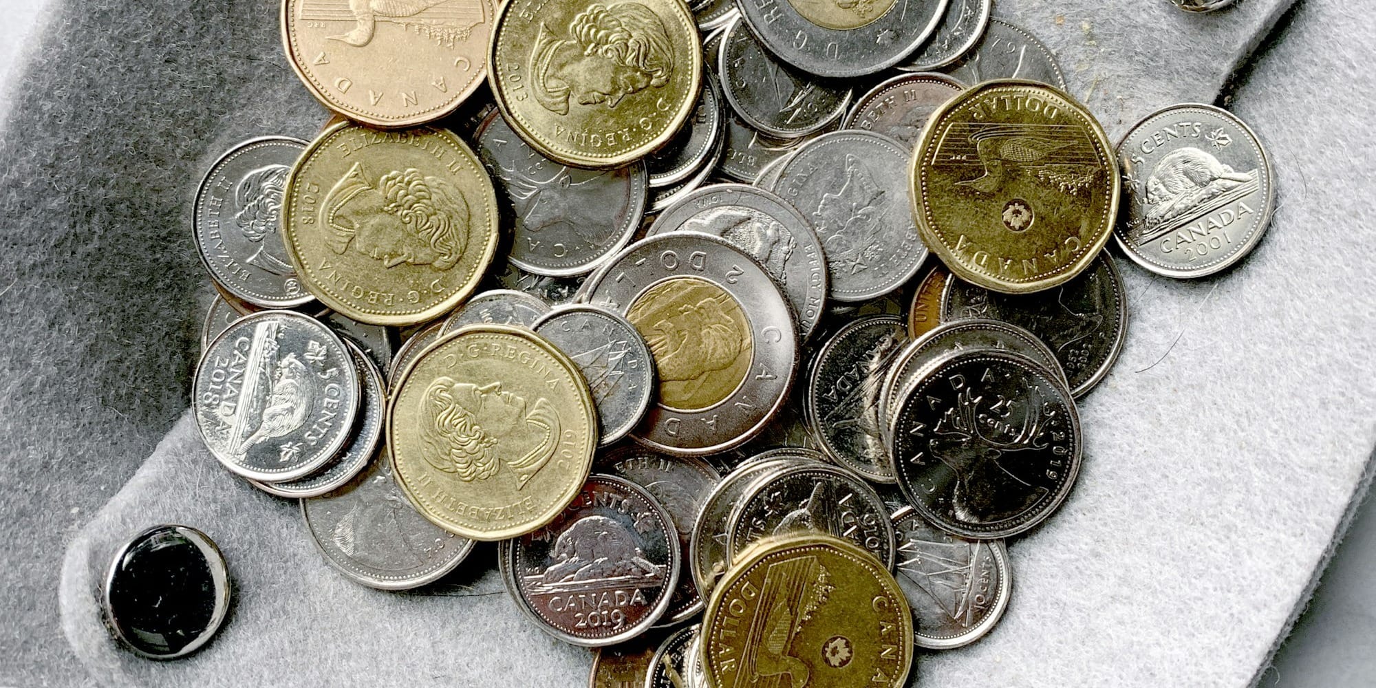 gold and silver round coins on gray surface